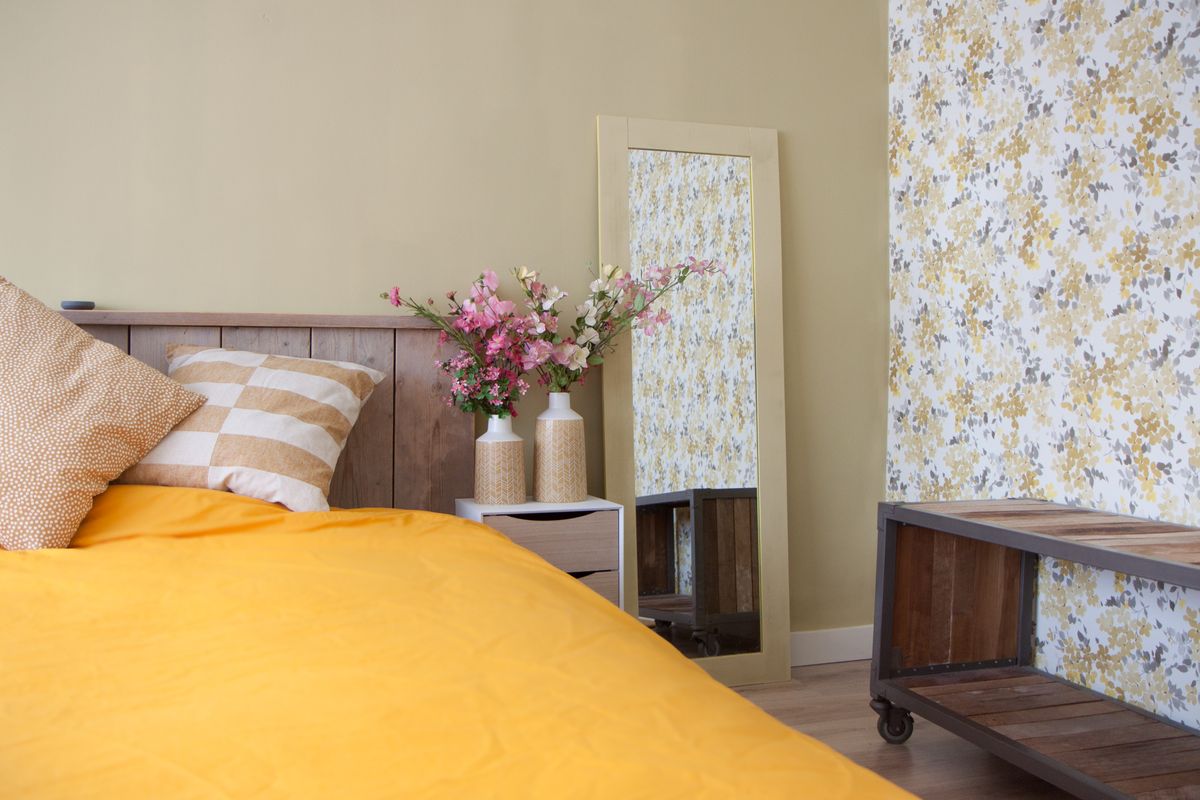 Slaapkamer, spiegel, bed, steigerhout, bloemen behang.